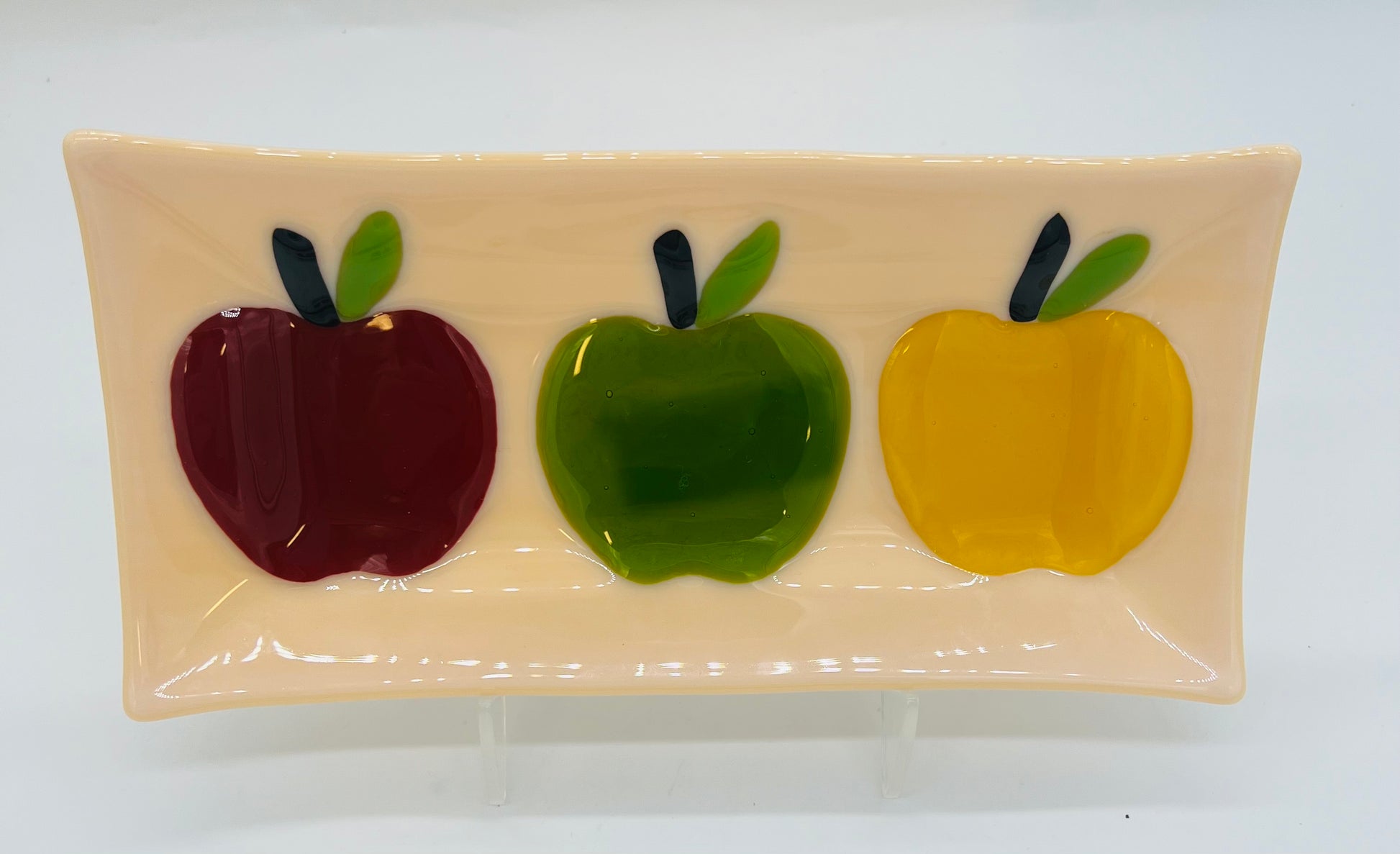 glass tray with three apples on it