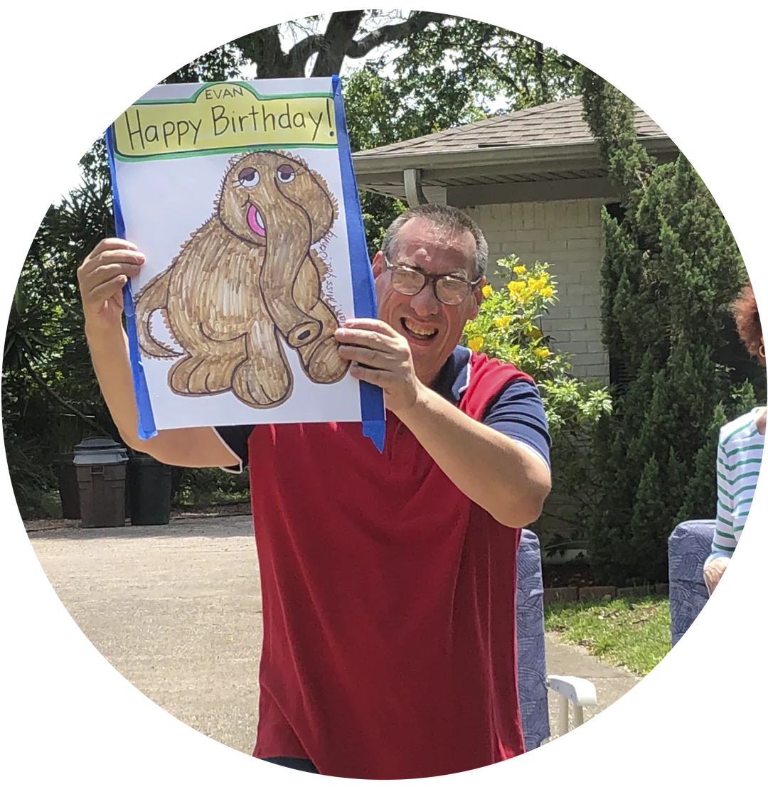 artist Evan holding happy birthday sign