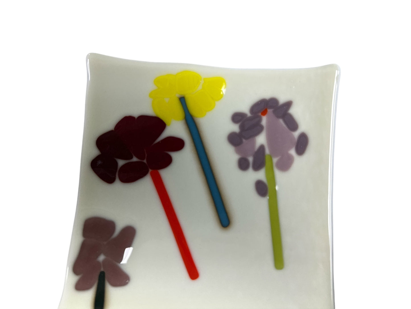 White tray with 4 neutral colorful flowers.