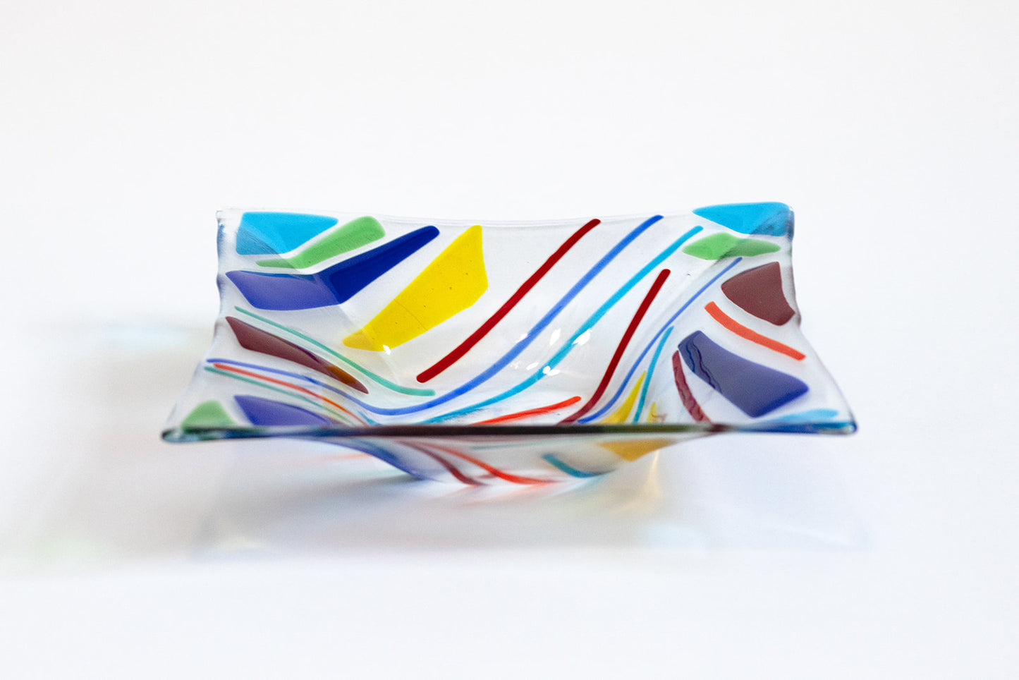 Square clear glass bowl with transparent triangles of blue, green, red, yellow glass