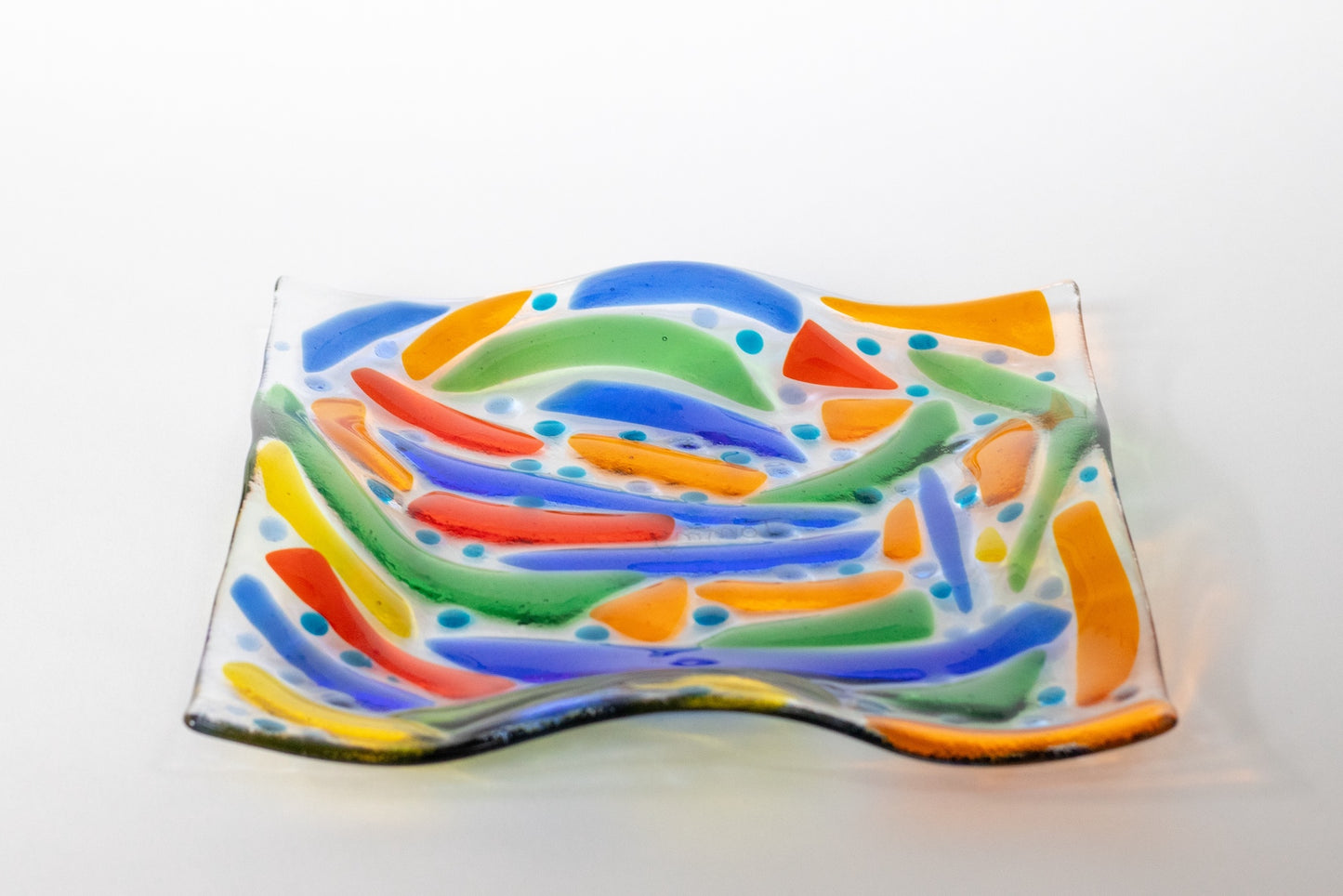 clear glass plate with transparent blue, green, orange and red
