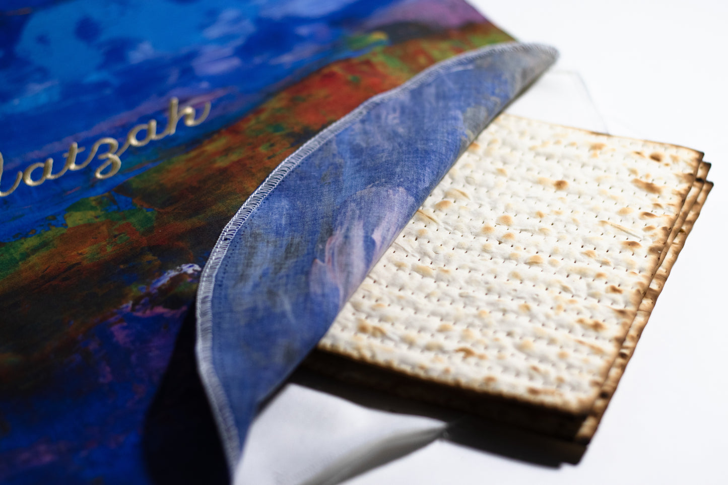 matzah cover holding matzah