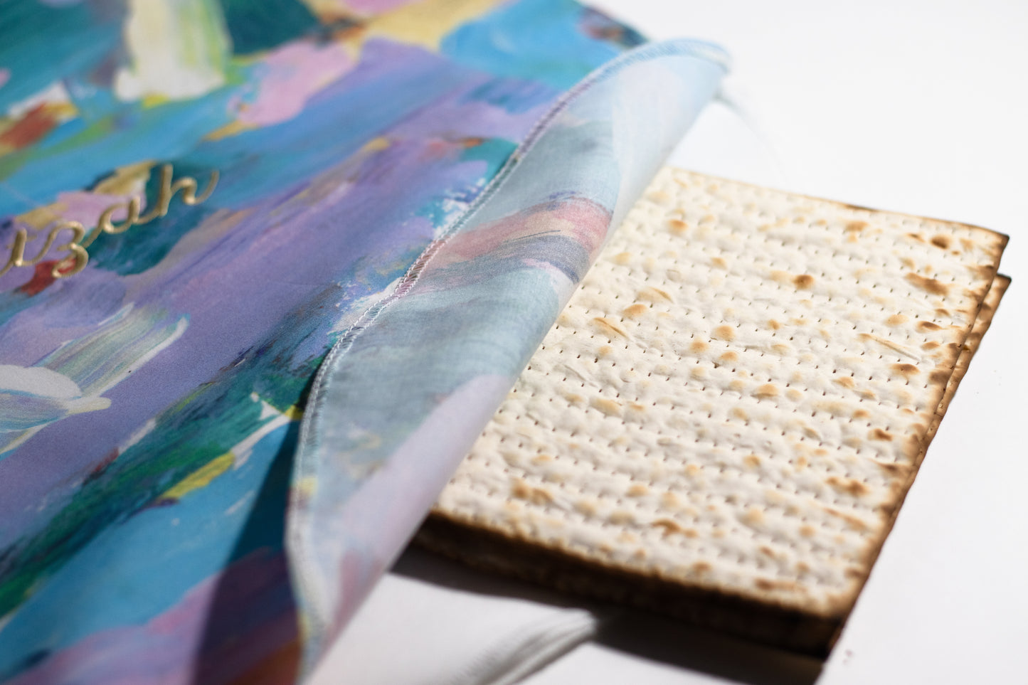 matzah cover holding matzah