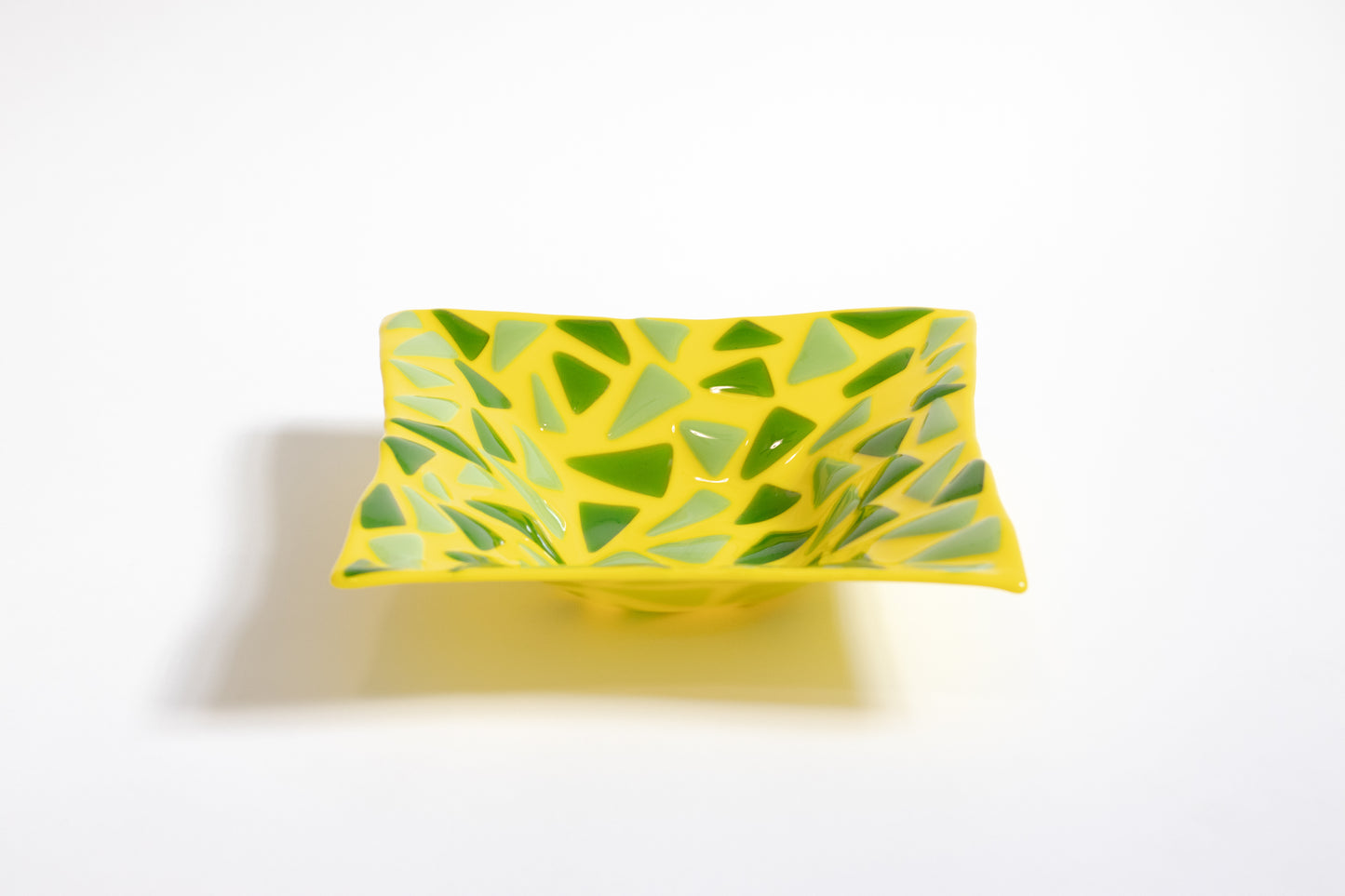 Yellow fused glass bowl with green triangles pattern