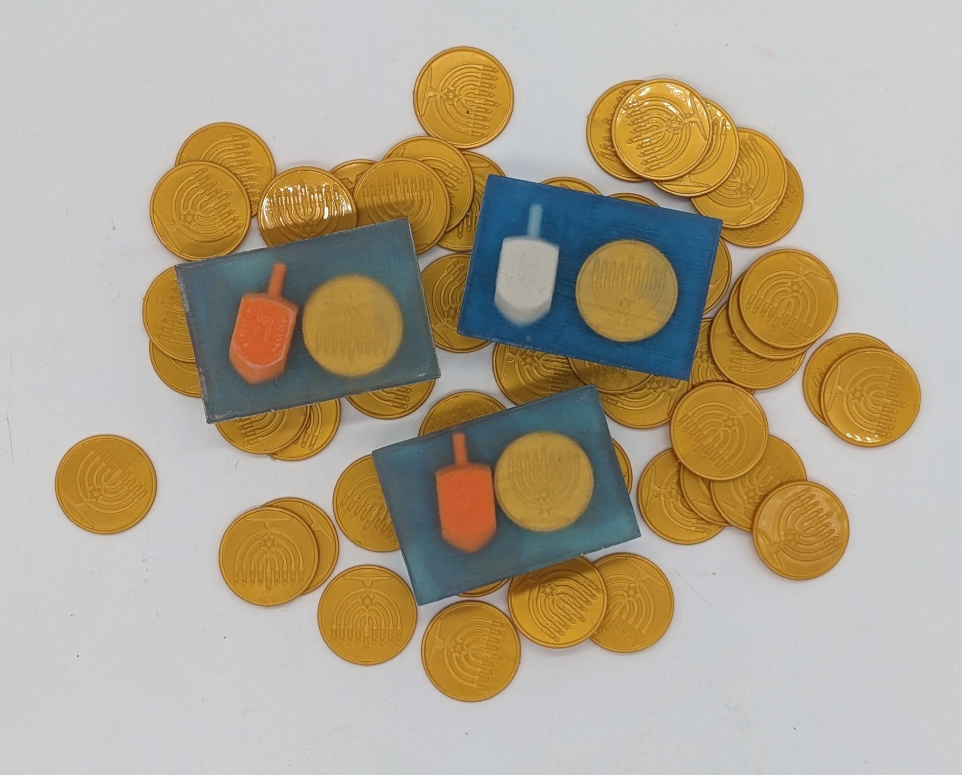 chanukah themed soap with dreidel and gelt embedded inside