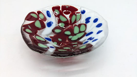 glass white and red bowl with dots of green and blue