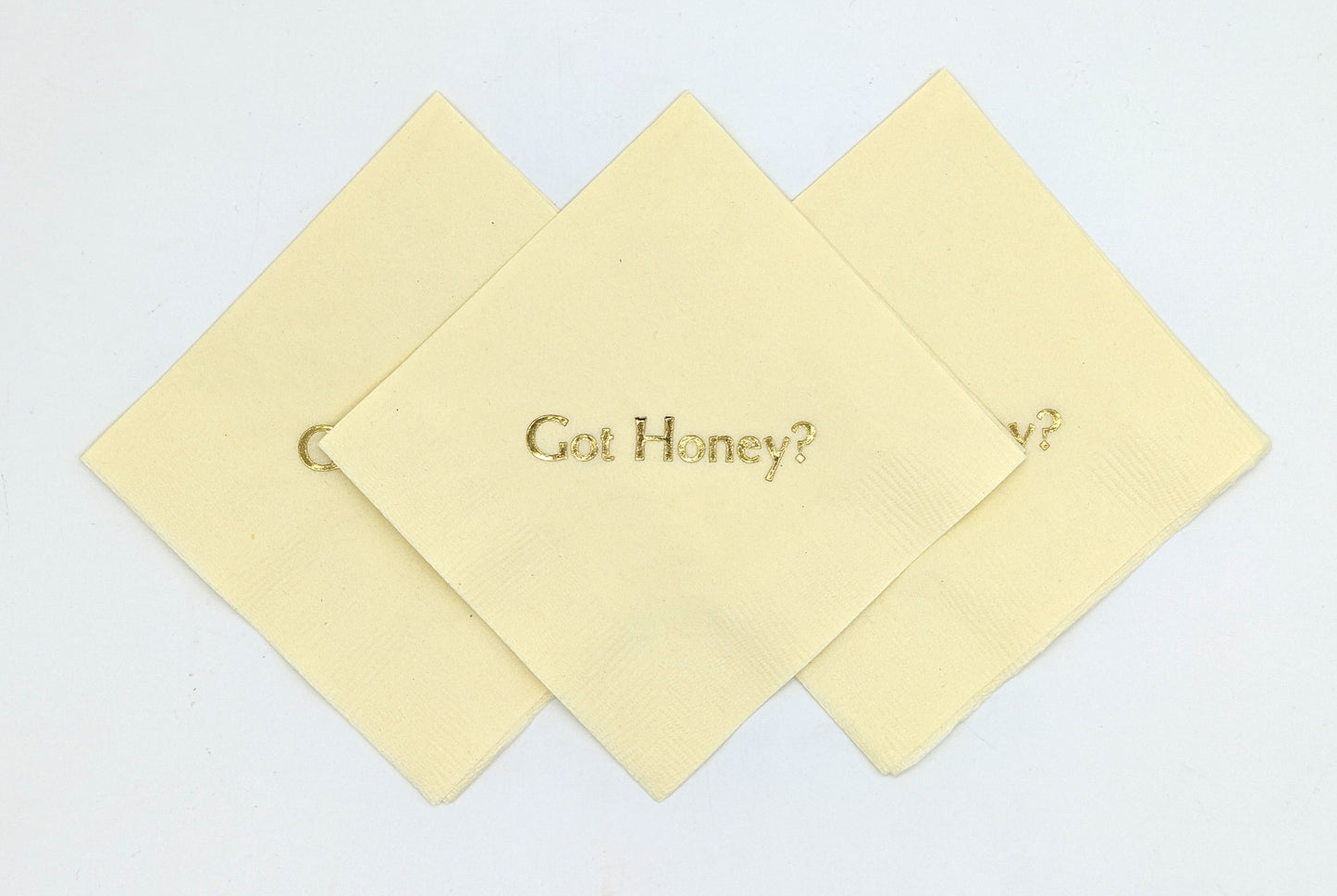 cream cocktail napkins with got honey? on it