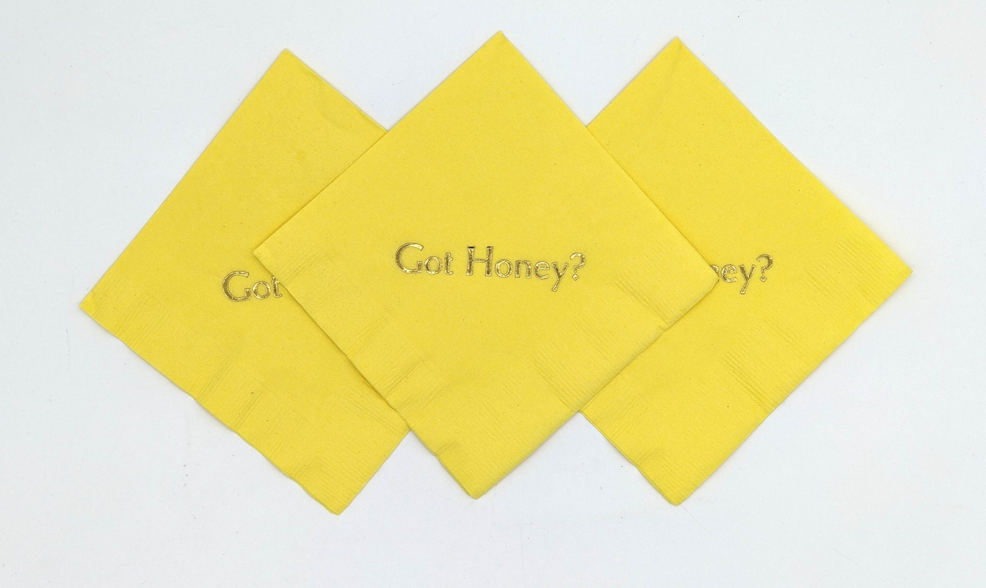 yellow cocktail napkins with got honey? on it