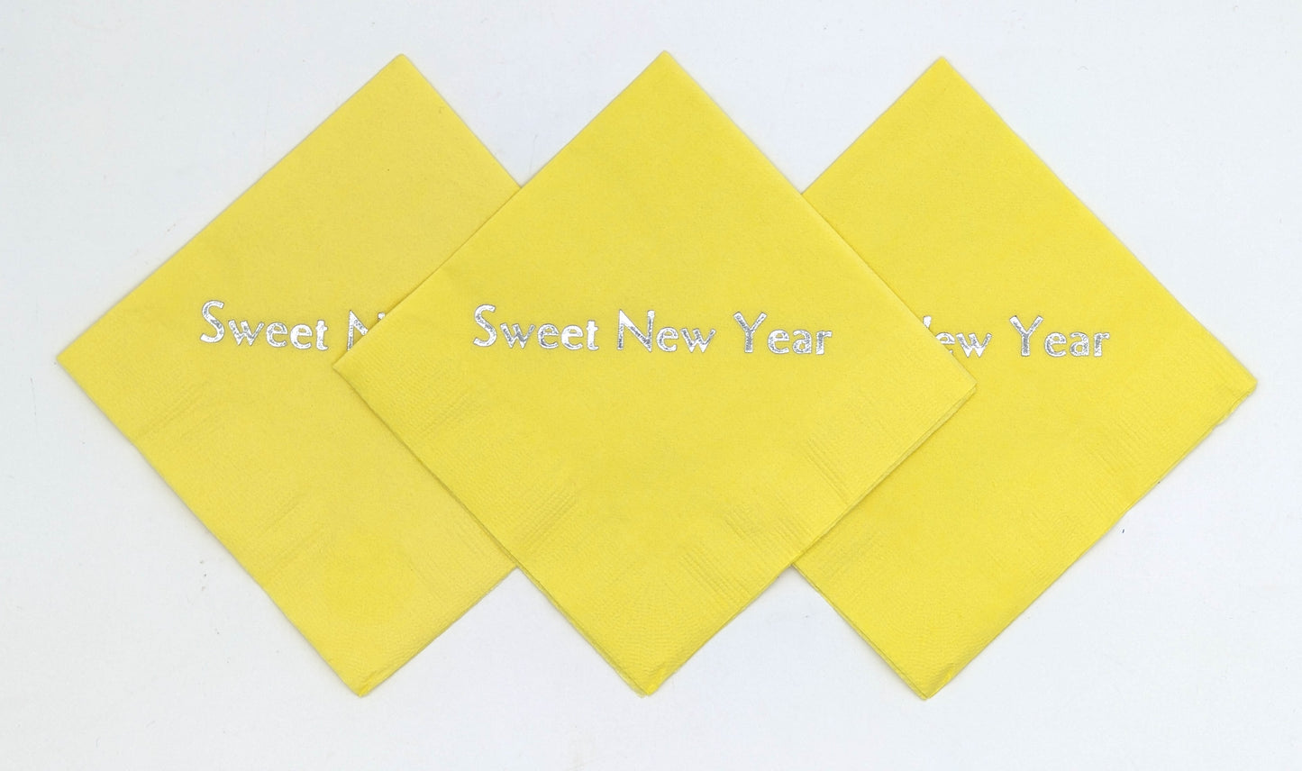 yellow cocktail napkins with sweet new year on it