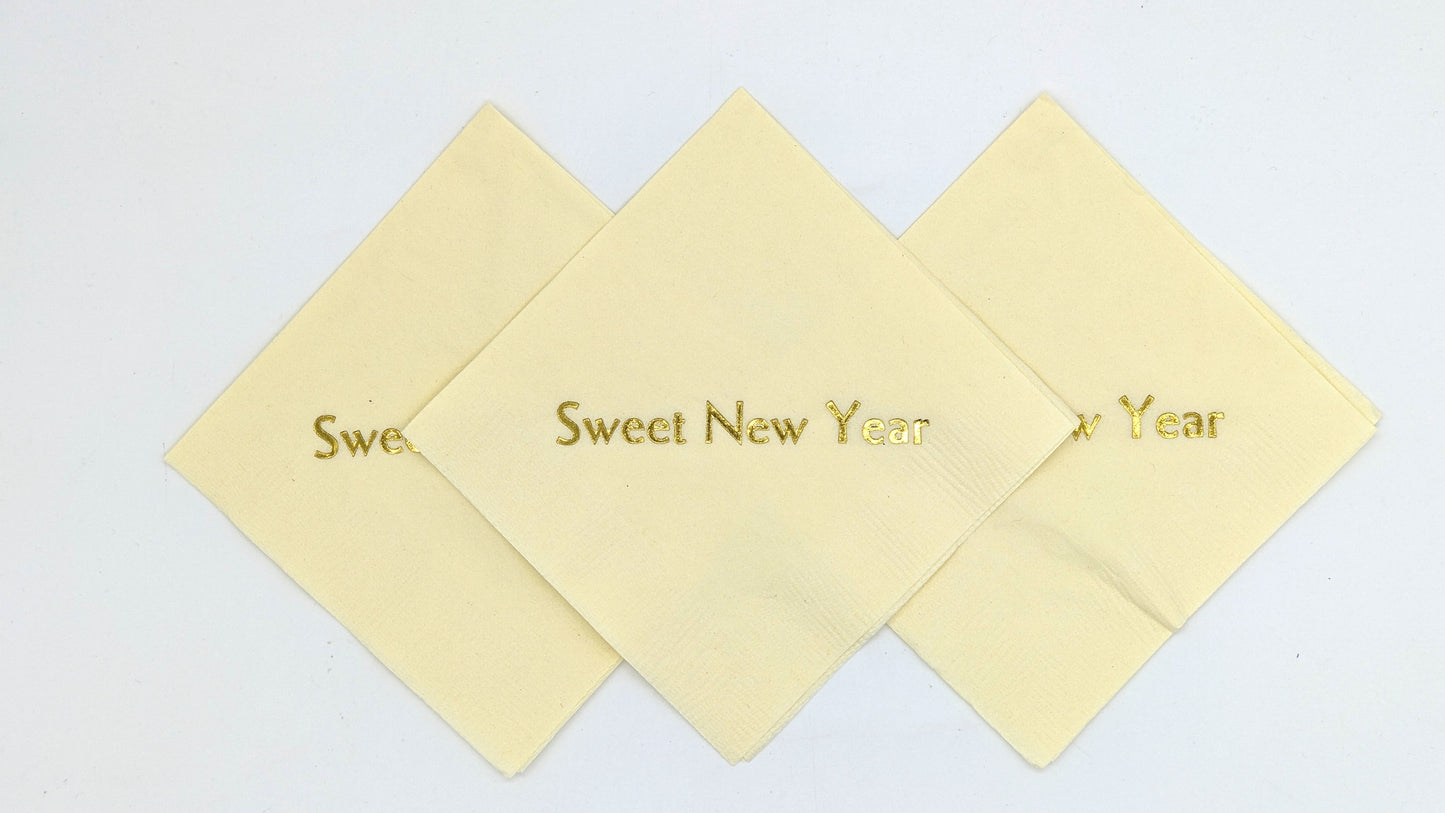 cream cocktail napkins with sweet new year on it