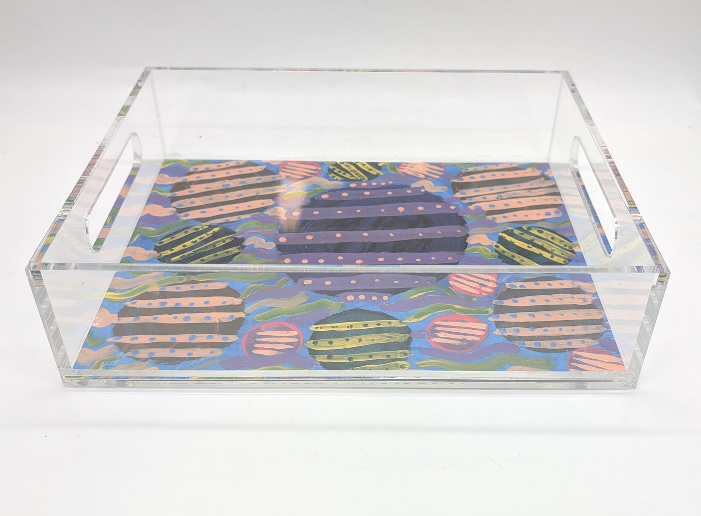 acrylic tray with a purple and pink circular design