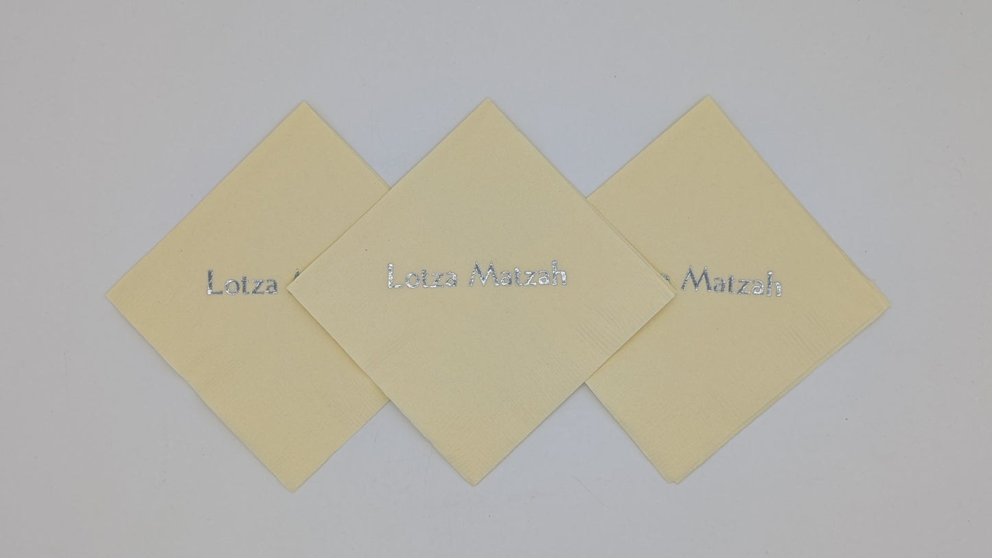 grouping of 3 cream napkins that say lots of matzah