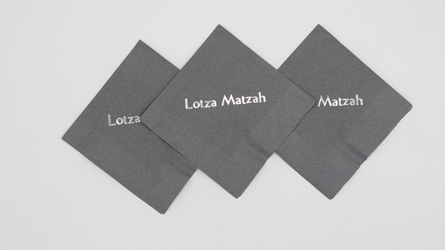 grouping of 3 gray napkins that say lots of matzah