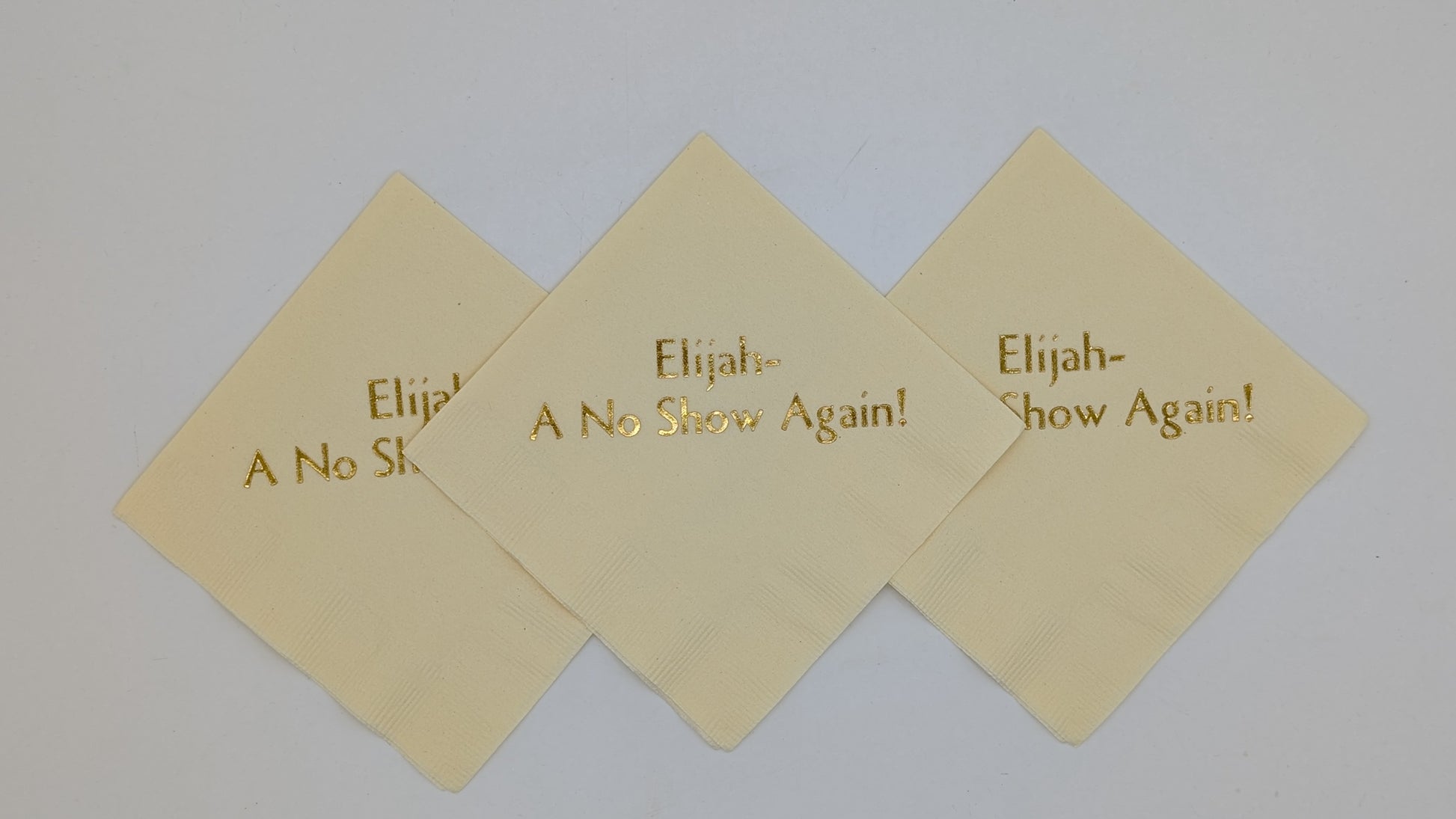 picture of 3 cream napkins with the saying Elijah a no show again