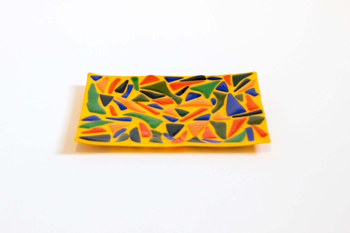 yellow plate with green, orange, blue, and black shapes