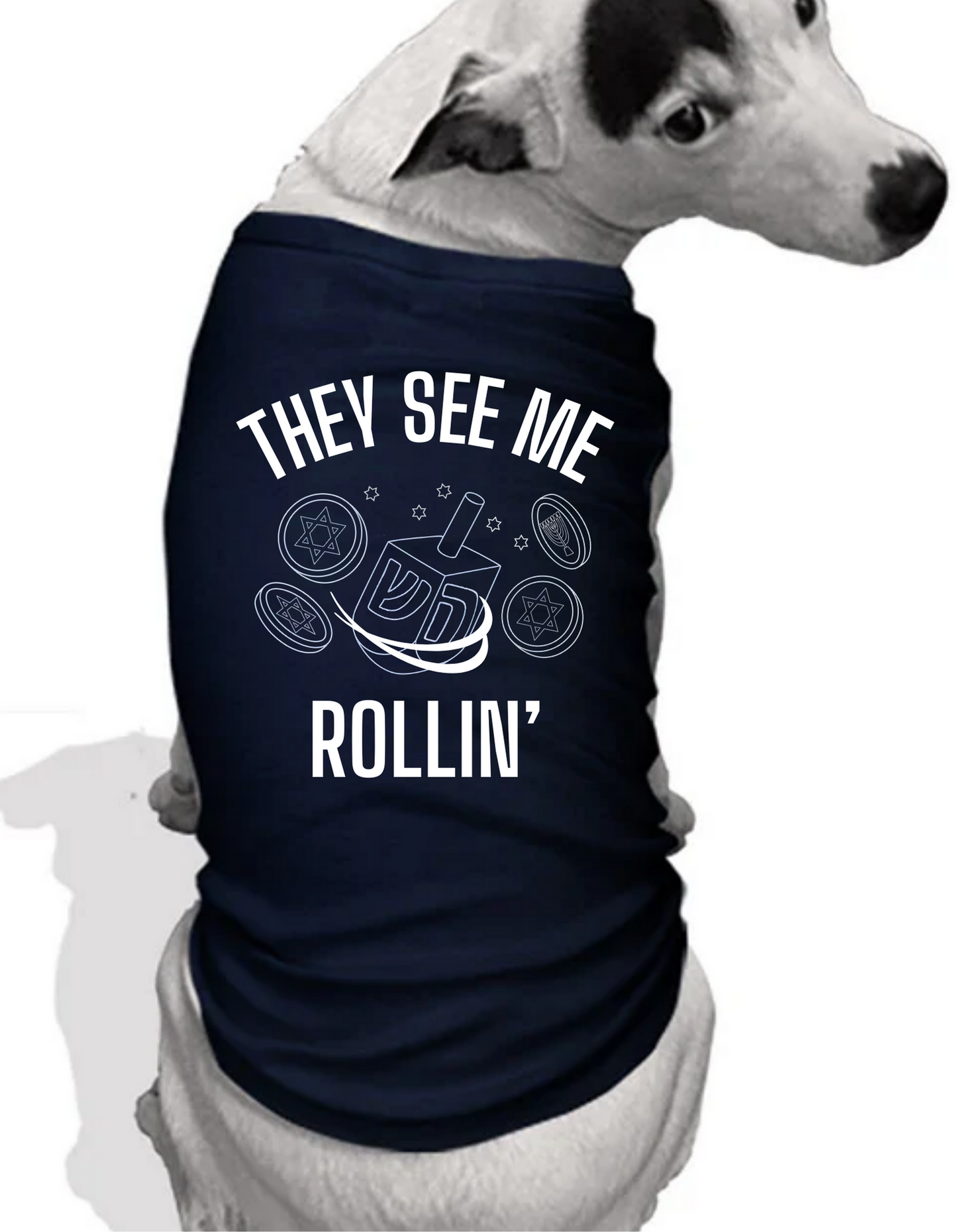 White dog wearing a Navy Blue Shirt with text that says 'They see me rollin' and picture of dreidel.