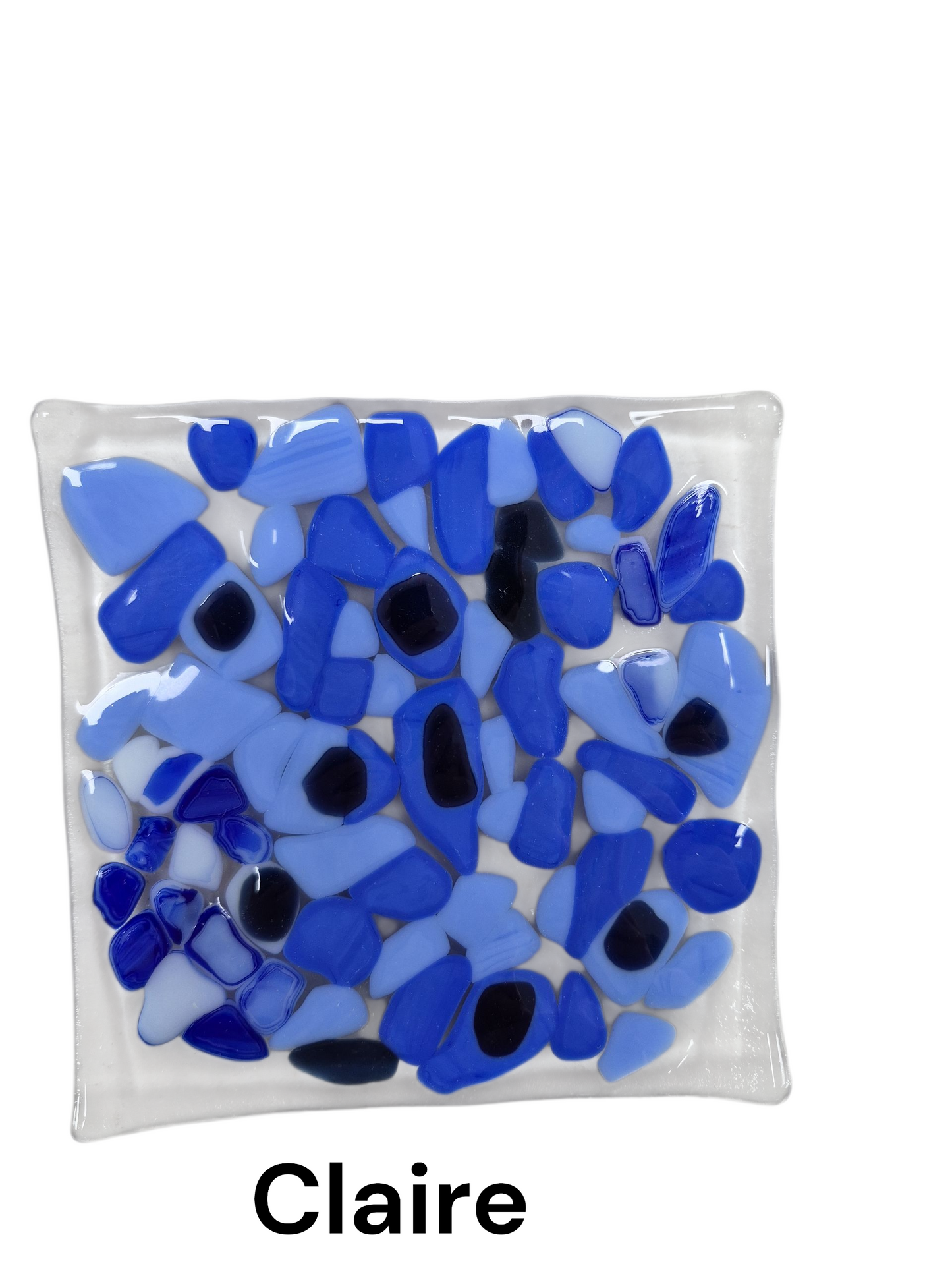 Handcrafted fused glass art tray, it features a captivating, dense mosaic of smooth glass pieces in varying shades of blue—ranging from pale sky blue to deep cobalt—creating a serene, water-like effect on a clear glass base.
Medium: Fused Glass
Size: Approximately 6" x 6"
Year: 2026