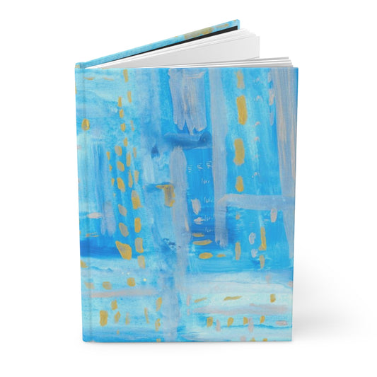 lined hardcover journal with a cover of blue, silver, and gold