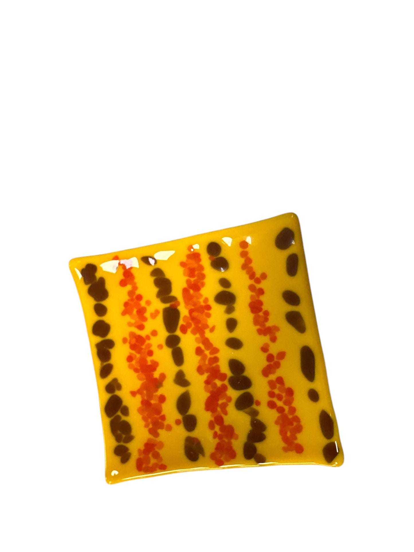 Colorful yellow glass wavy plate with brown and orange dots.