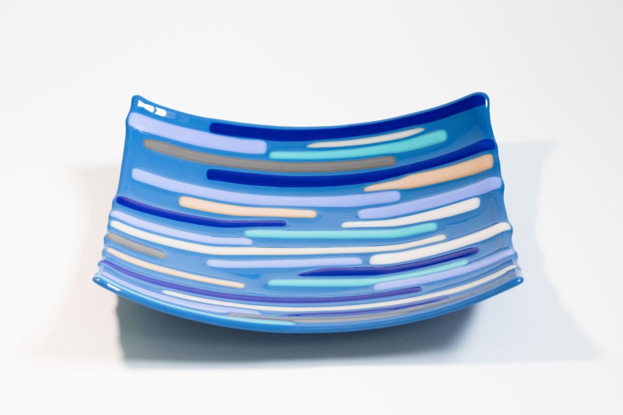 square Blue glass bowl with various shades of blue, white, and gray lines across