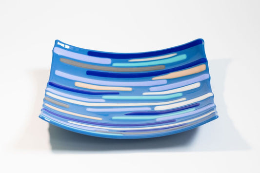 square Blue glass bowl with various shades of blue, white, and gray lines across