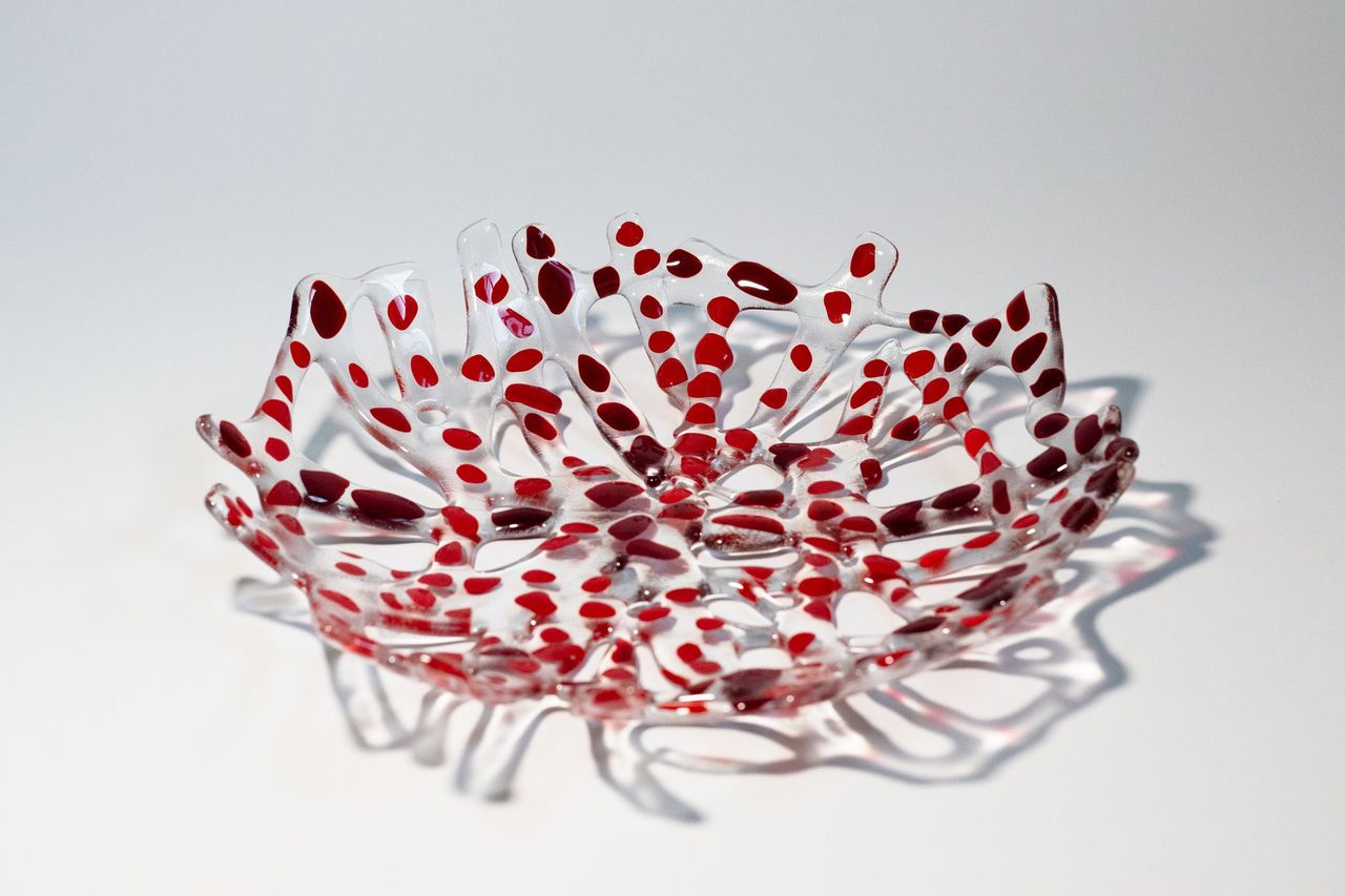 Clear branch glass bowl with dots of reds forming a circular bowl
