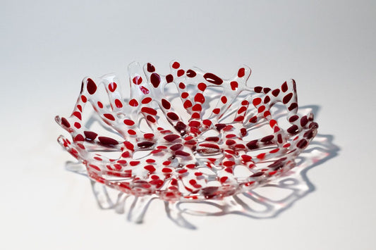 Clear branch glass bowl with dots of reds forming a circular bowl