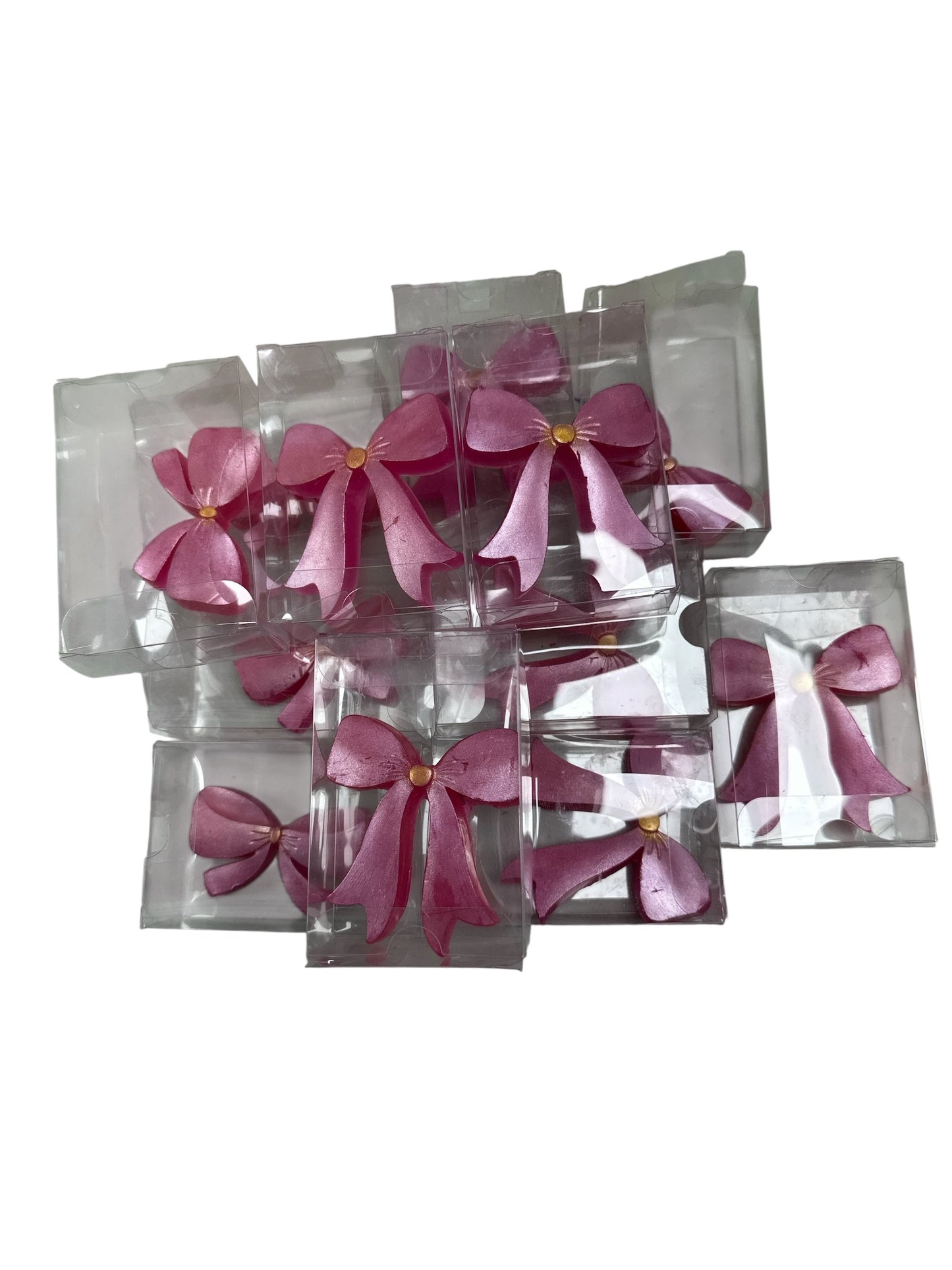 Pink decorative bows in clear packaging on a white background
