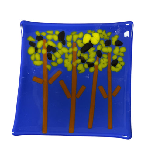 blue glass dish with trees on it