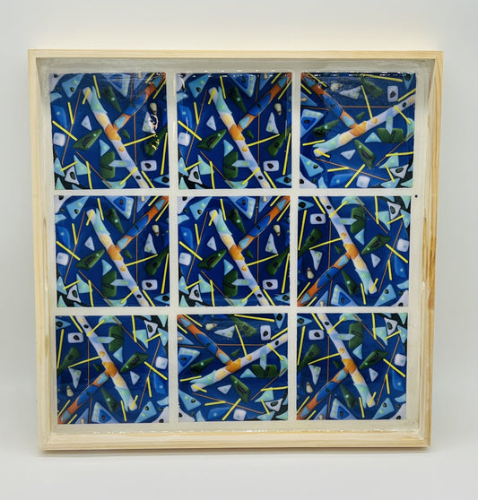 square wooden tray filled with blue tiles.
