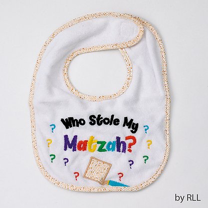 White bib with a matzah trim edge and Who Stole My Matzah? slogan in black and rainbow