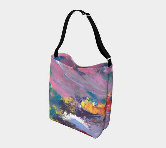 Crossbody tote with black strap depicting yellow, red, pink, turquoise, purple and lavender streak design