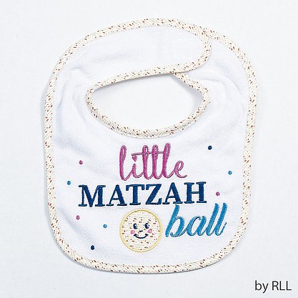 White bib with a matzah trim edge and little matzah ball slogan in purple and blue