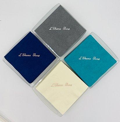 Gray, blue, teal and ivory packaged napkins with L'Shana Tova slogan