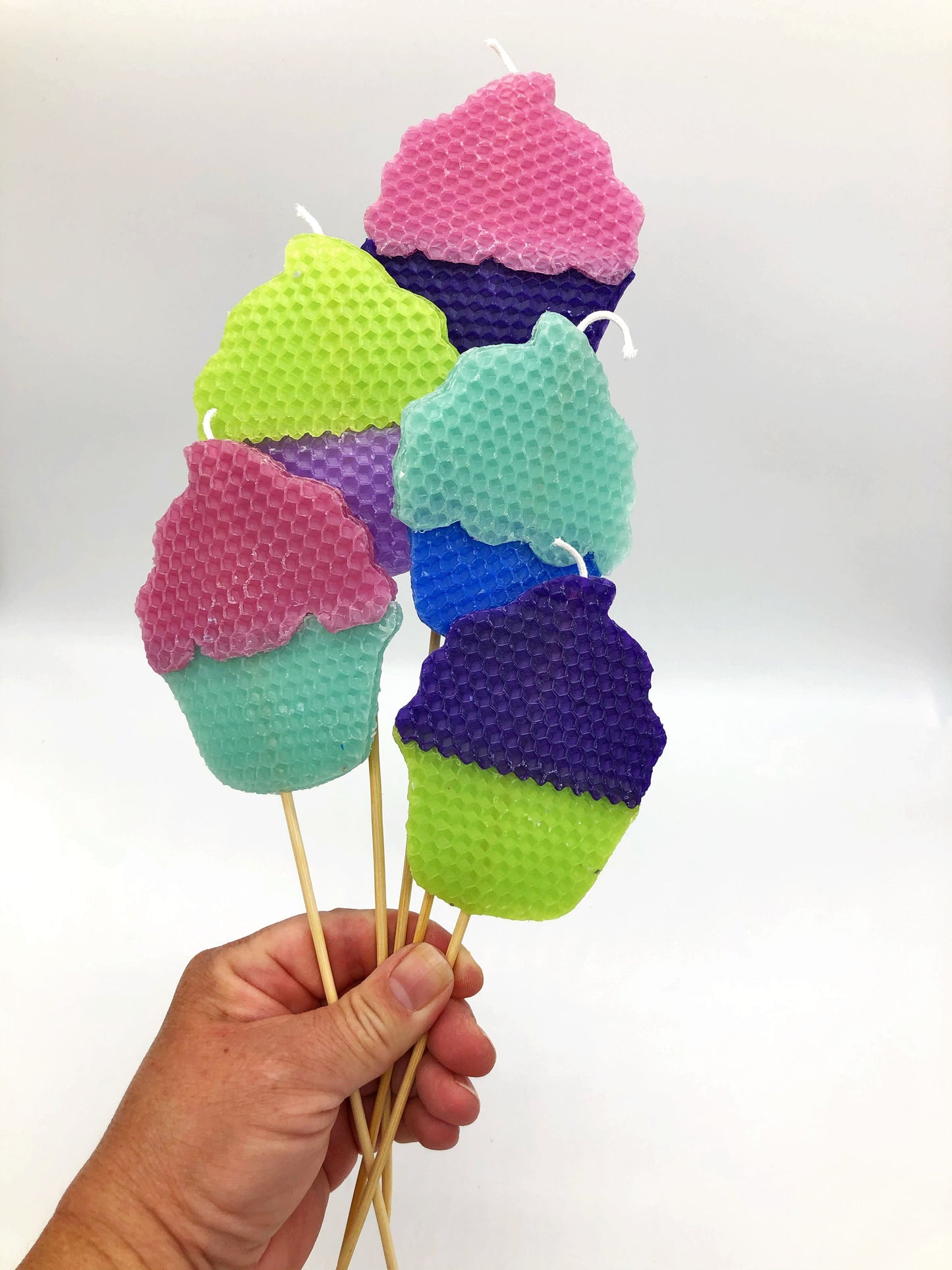Beeswax candles in the shape of cupcakes with different colored frosting and bases