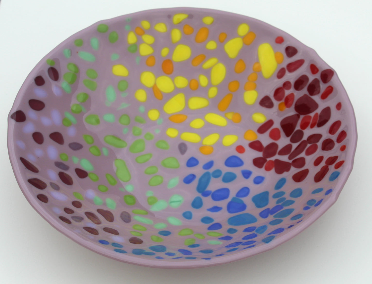 purple glass bowl with spots of red, yellow, green, and blue sectioned off