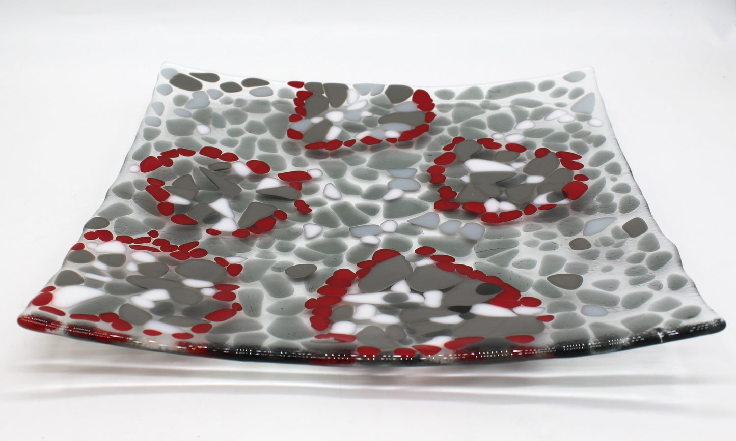 glass platter with grays , white and highlights of red