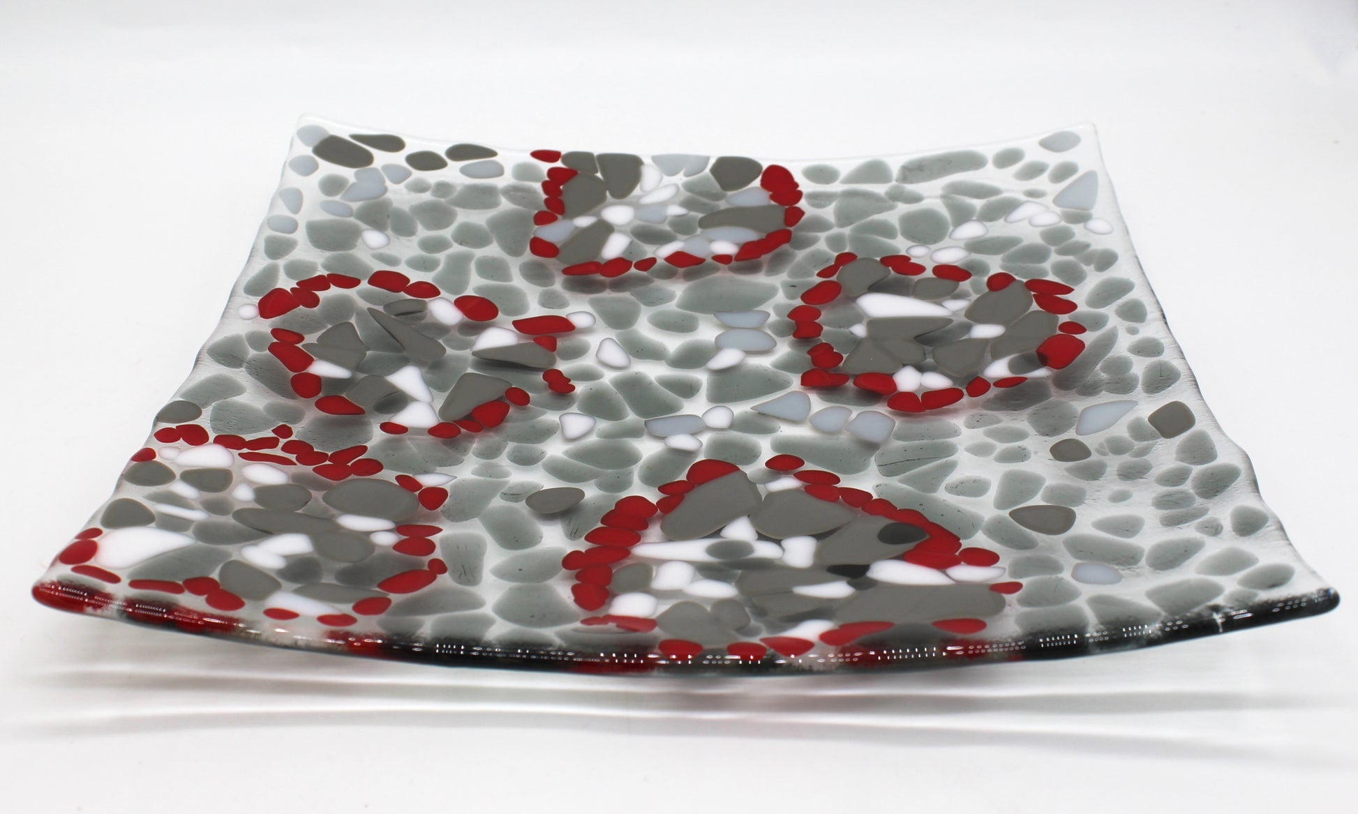 glass platter with grays , white and highlights of red