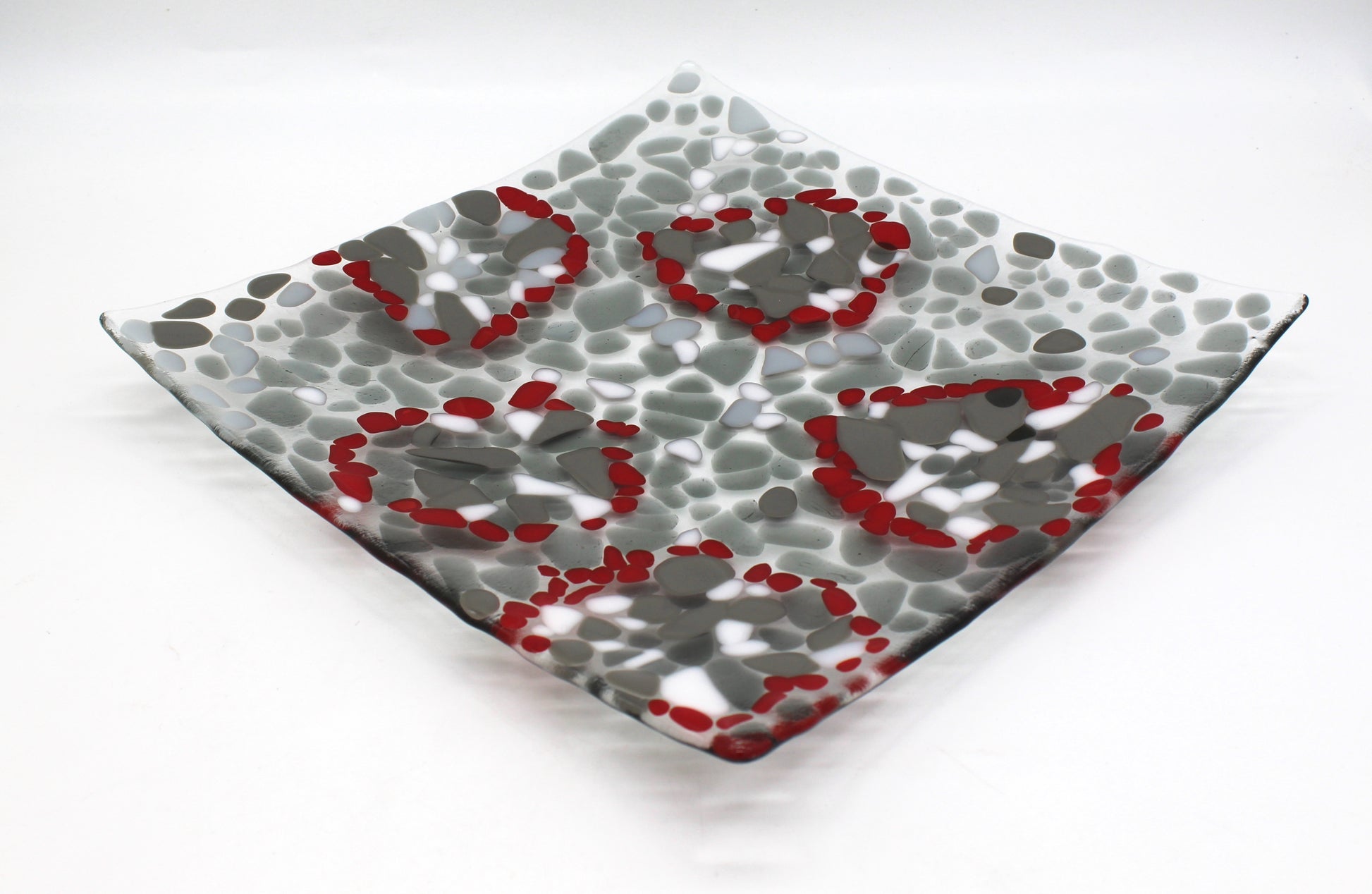 glass platter with grays , white and highlights of red