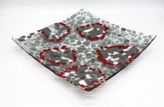 glass platter with grays , white and highlights of red