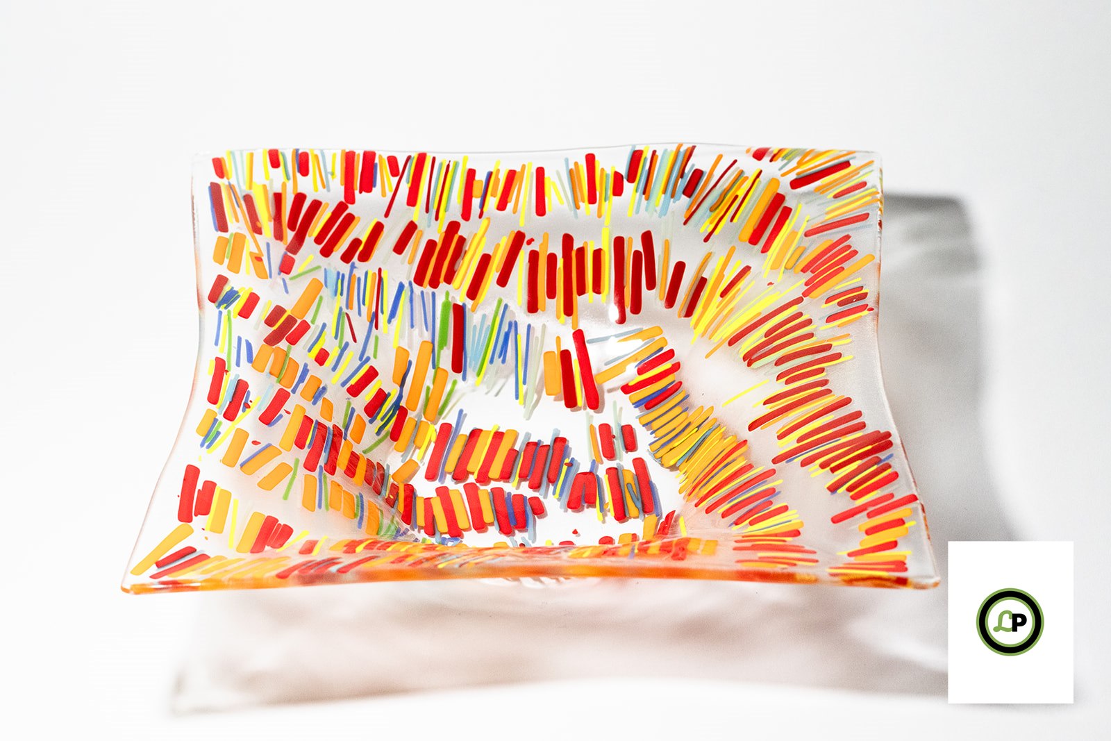 glass bowl with lines of yellow, orange, and red