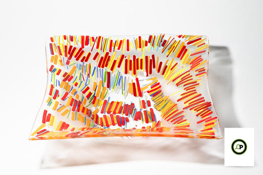 glass bowl with lines of yellow, orange, and red