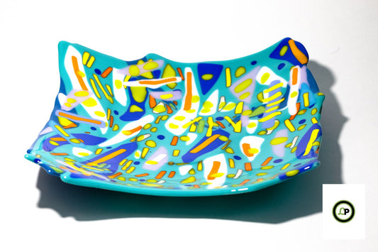 glass bowl with lines ontop of various blues
