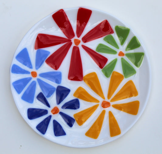 white glass plate with flowers on top