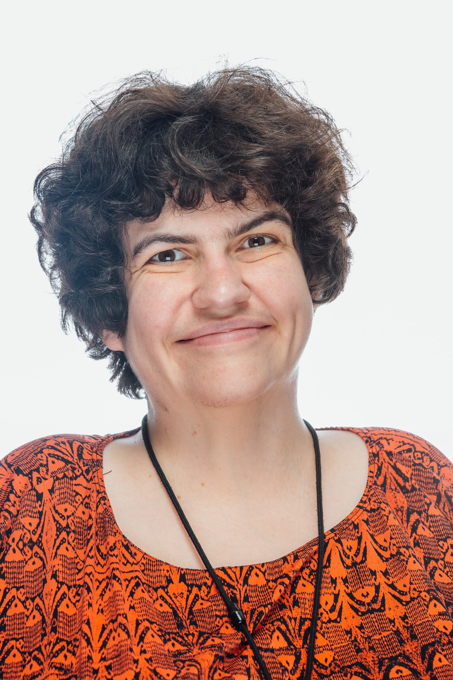 Woman with short wavy hair and a big smile