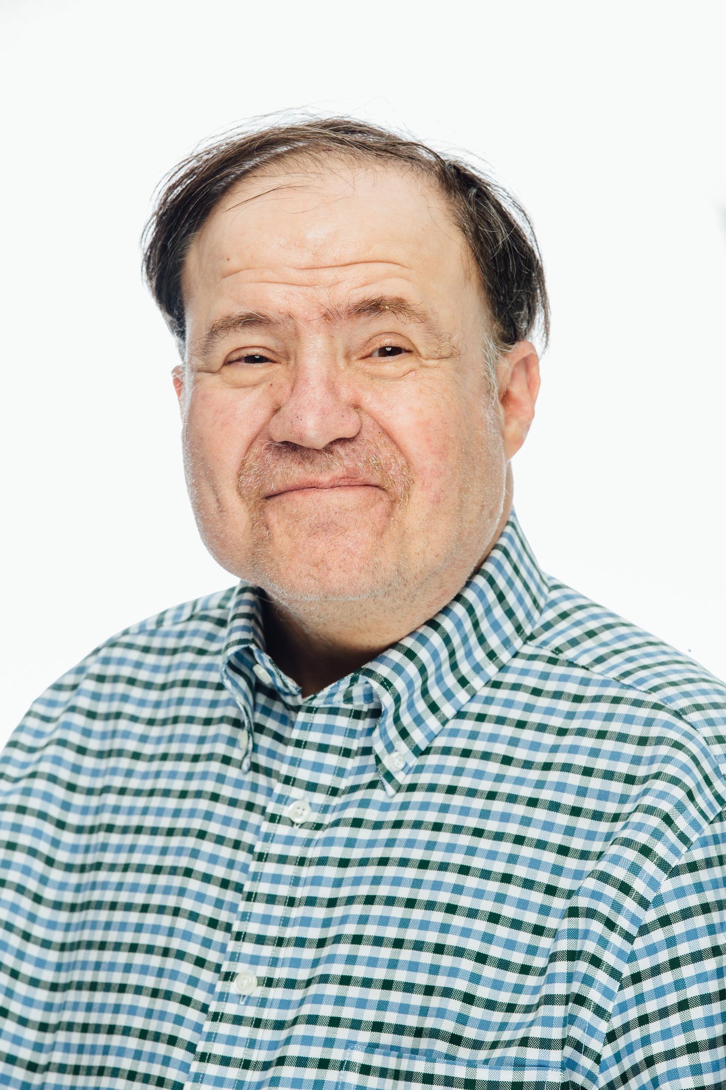Photograph of artist wearing a plaid shirt