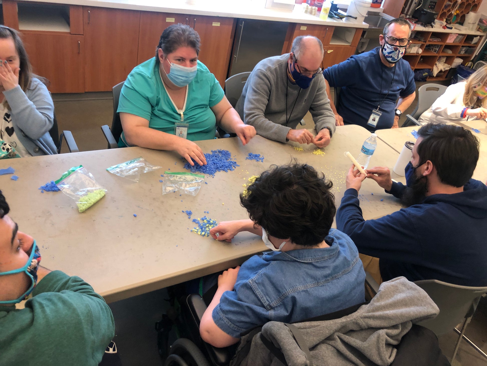 picture of a group of people who are making dots of wax colors
