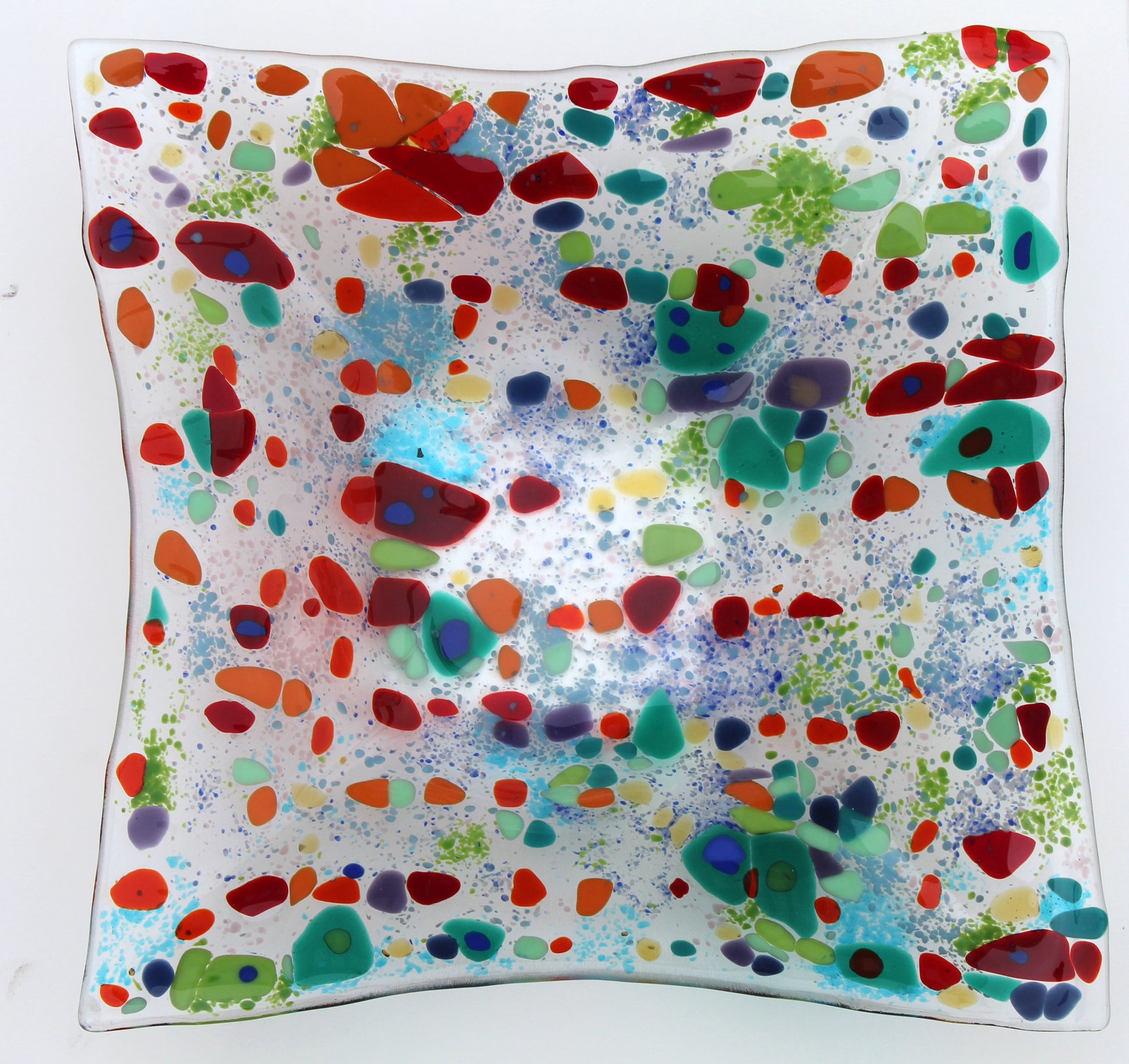 clear glass square bowl withe spots of red and greens, with specks of blue