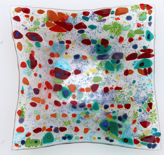 clear glass square bowl withe spots of red and greens, with specks of blue