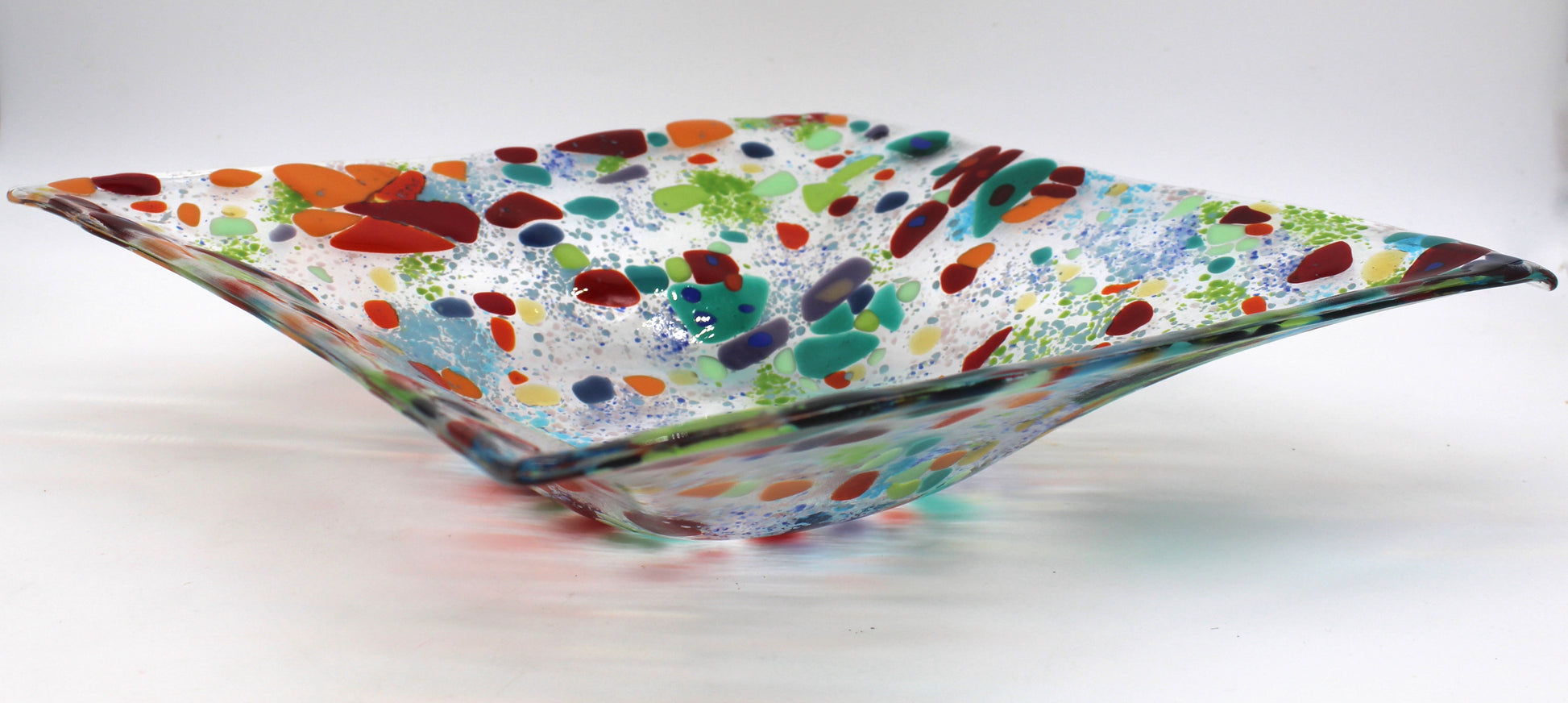 clear glass square bowl withe spots of red and greens, with specks of blue